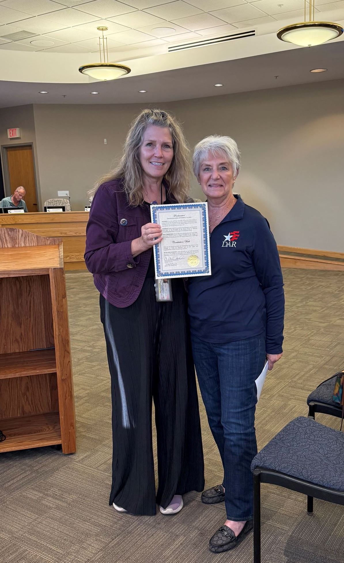Representative from Daughters of the American Revolution and Mayor Missey signing proclamation